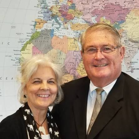 Pastor Rick Shrader and his wife, Jodi, in front of a world map